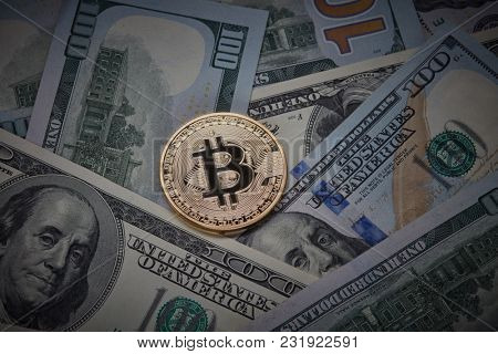 Many dollar bills and a gold coin bitcoin.