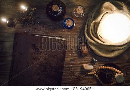 Crystal Ball And Magic Book With Copy Space On Fortune Teller Magic Desk Table Background. Seance Co