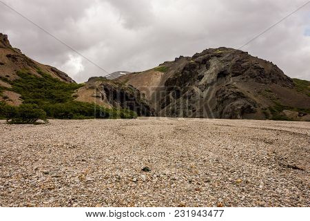 Icelandic Landscape With Red Hills In Lonsoraefi In Cloudy Weather