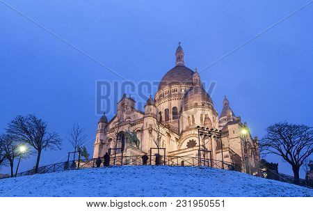 The Basilica Sacre Coeur Covered With Snow. It Is A Roman Catholic Church Located At The Summet Of T