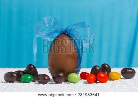 Easter Chocolate Egg With Lots Of Chocolate Candies In Decoration