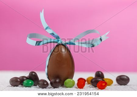 Easter Chocolate Egg With Lots Of Chocolate Candies In Decoration