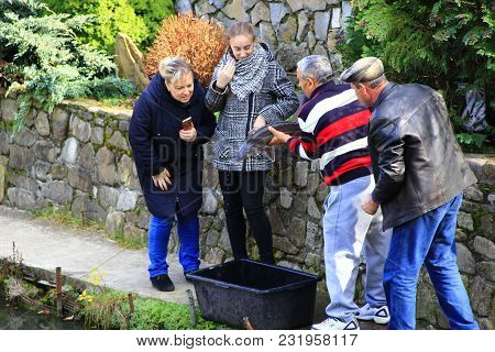 Kosiv Ivano-frankivsk Region/ Ukraine - 27 October 2017 / Ukraine: Man Showing Caught Sterlet To Wom