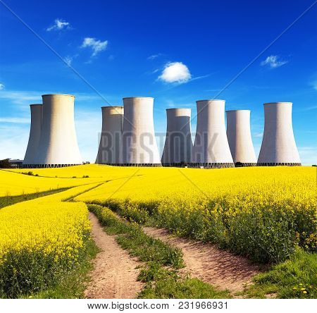 Panoramic View Of Nuclear Power Plant Jaslovske Bohunice With Golden Flowering Field Of Rapeseed, Ca