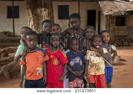 Nhacra, Republic Of Guinea-bissau - January 28, 2018: Portrait Of A Group Of Children In Front Of A 