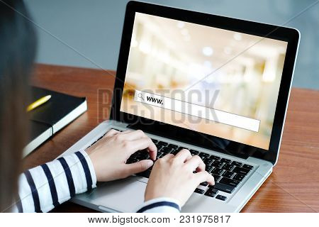 Hand Tying Labtop Computer With Www. On Search Bar Over Blur Store Background On Screen, On Line Sho