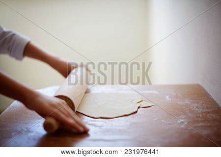 Cute Little Boy Playing With Dough Rack And Smiling While Cooking In Kitchen At Home. Kid Is Having 