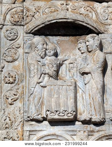 VERONA, ITALY - MAY 27: Presentation of Jesus in the Temple, medieval relief on the facade of Basilica of San Zeno in Verona, Italy, on May 27, 2017.