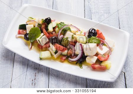 Greek salad with feta cheese cubes and fresk vegetables