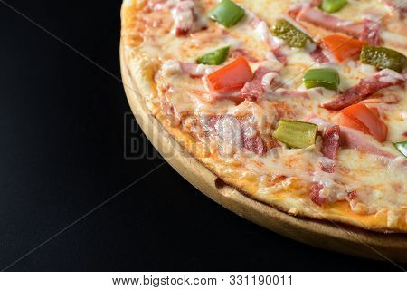 Classic Ham Pizza Isolated On Black Background
