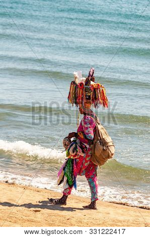 Tenda Gialla, Province Of Grosseto, Tuscany, Italy - September 03, 2019: The African Woman Walking O
