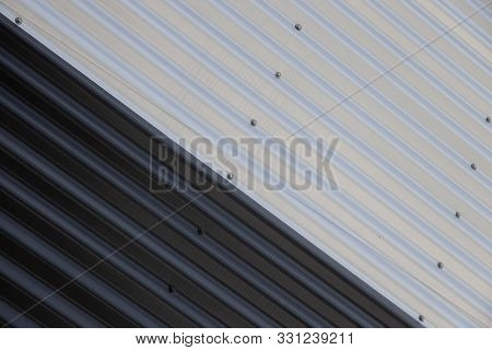 Close-up Of Junction Of Black And White Corrugated Surfaces. Industrial Yin Yang