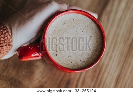 Red Cup With Mokachino Coffee In A Cafe On A Dark Background