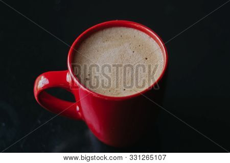 Red Cup With Mokachino Coffee In A Cafe On A Dark Background
