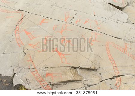 Rock Art In Alta Fjord, Norway. Ancient Symbols, Real Drawing,  Texture In Stone. Red Ocher Paint. H