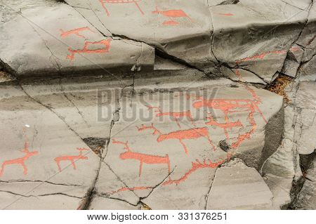 Rock Art In Alta Fjord, Norway. Ancient Symbols, Real Drawing,  Texture In Stone. Red Ocher Paint. H