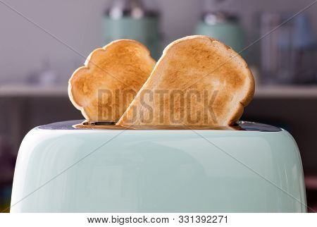 Close Up Of Bread Slices In A Green Toaster