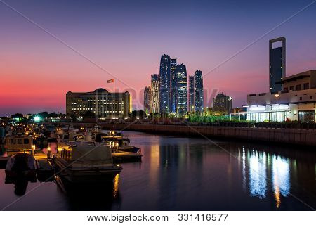 Abu Dhabi Modern Skyline Reflected In The Water At Twilight