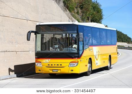 Saint Gotthard Pass, Switzerland - September 13, 2019: Yellow Suburban Coach Bus Setra S415h At The 