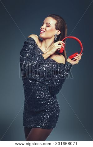 Young Caucasian Celebrity Woman Holding Heaphones And Dancing, Eyes Closed