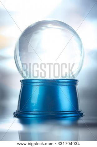 Blank empty snowglobe. Glass snow globe on blue base.
