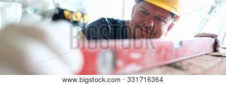 Portrait Of Bearded Builder Wearing Hard Gloves To Keep Hands Unharmed. Pedantic Man Using Special T