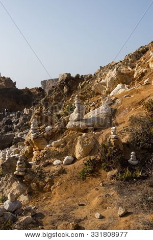 Beach With Stacks Of Rocks Called A Cairns. Peniche Portugal