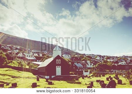 Sorvagur, Faroe Islands, Denmark - July 09, 2019: Traditional Faroese Village With Harbor Beach And