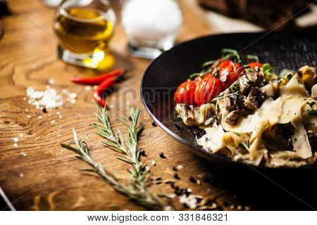 Black Angus pappardelle pasta with beef, champignon and parmegano cheese