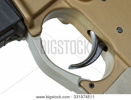 Ar-15 Trigger On A Gold Colored Gun With White Background
