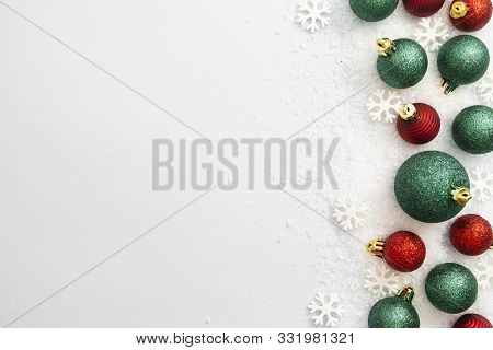Christmas Glitered Green And Red Baubles, Balls Isolated On Snow. Winter Abstract Border Mockup. Cop