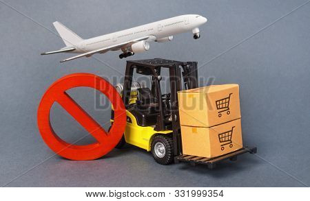 Yellow Forklift Truck Carries Boxex And A Red Prohibition Symbol No. Embargo Trade Wars. Restriction