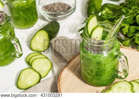 Green Smoothie With Cucumber In A Glass Jar. Fresh Ripe Vegetables, Greens, And Chia Seeds