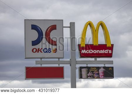 Close Up View Of Logotype Board Of Well-known Gas Station Okq8 And Mcdonald's Logotype Board On Whit