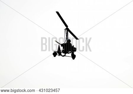Flying Autogyro Silhouette On White Background.