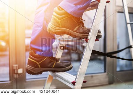 Step Ladder Safety. Climbing Man Foot And Shoe