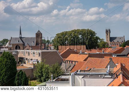Sluis, The Netherlands - August 5, 2021: Red Roof Skyline With Sint Johannes De Doperkerk (john The 