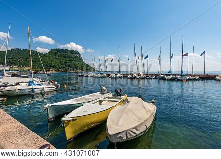 Moored Boats In The Port Of The Small Village Of Garda, Tourist Resort On The Coast Of Lake Garda (l