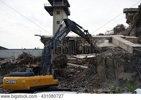 Moscow Russia - August 2021: An Excavator Equipped With Special Equipment Destroys An Old Building.