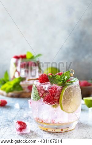 Hard Seltzer Cocktail With Raspberries And Lime On A Gray Stone Table Top. Copy Space.