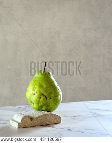 A Large Fresh Pear Stands On A Marble Stand, Balancing. The Concept Is A Balance Of Fresh Fruits. Co