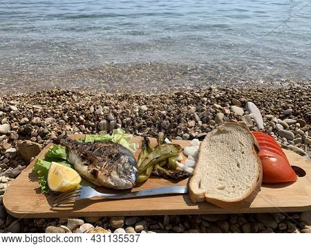 Fresh Grilled Fish With Lemon And Cherry Tomatoes On A Wooden Tray.