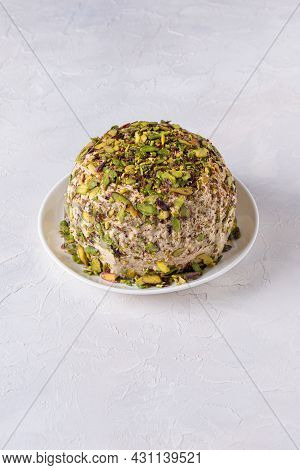 Sesame Halva With Pistachios Nuts On White Plate On White Background. High Angle View. Copy Space. T