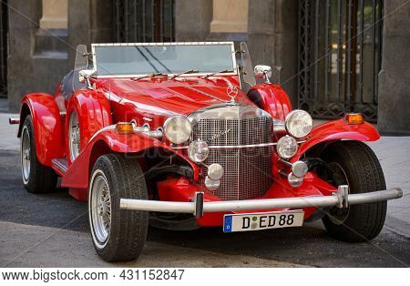 Bucharest, Romania - August 19, 2021: A Red Excalibur 1970s Ss Car Is Parked In Front Of The Marmoro