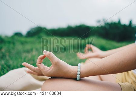Woman Practicing Yoga Lesson, Breathing, Meditating Exercise, Outdoor In Grass Field. Well Being, We