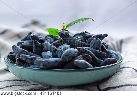 Closeup Fresh Blue Honeysuckle Or Haskap Berry On Plate On Fabric Napkin, Summer Fruit Dessert, Natu