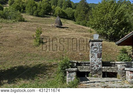 Vasiliovo, Bulgaria -  July 21, 2012: View Of A Mountain Pasture With Traditional Haystacks For The 