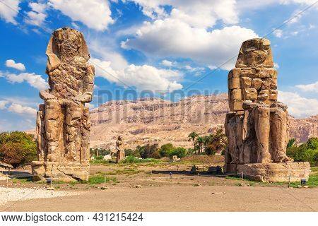 The Colossi Of Memnon In The Theban Necropolis, Statues Of The Pharaoh Amenhotep, Luxor, Egypt.