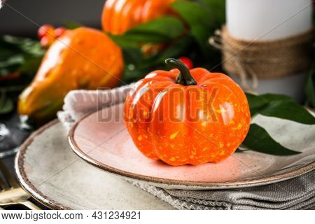 Autumn Table Setting With Plate, Pumpkin And Candles.