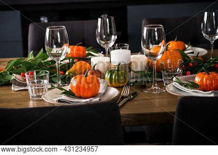 Autumn Table Setting With Plate, Pumpkin And Candles.